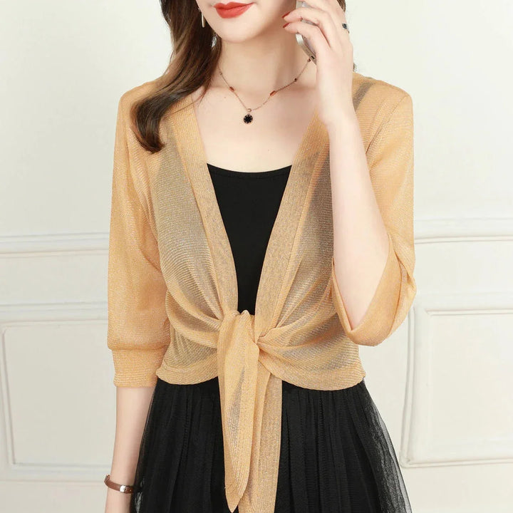 Chic sheer women's blouse with 3/4 sleeves and a fashionable tie front detail.