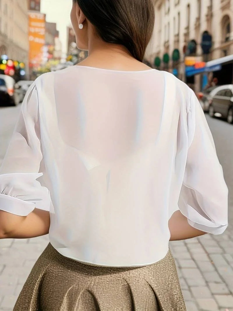 Lightweight women's sheer tie-front blouse, great for layering in warm weather.