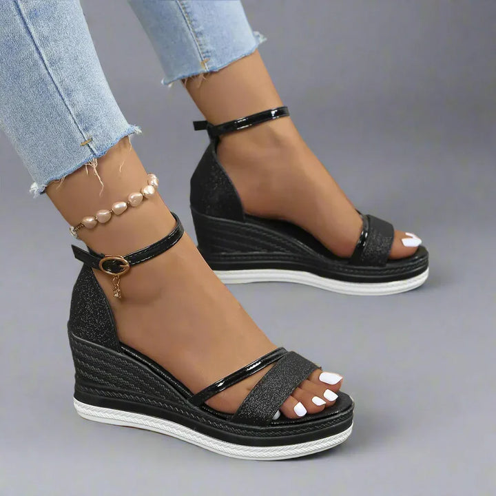 Chic women's platform wedge sandals featuring sparkling glitter and a secure ankle strap, ideal for stylish summer footwear.
