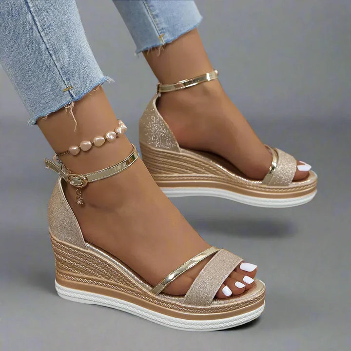 Dazzling women's glitter platform sandals with a comfortable wedge heel and supportive ankle strap for festive occasions.