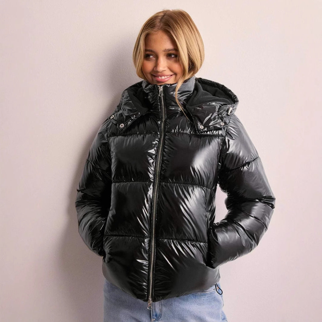 Close-up of the shiny fabric on a women's quilted hooded jacket.