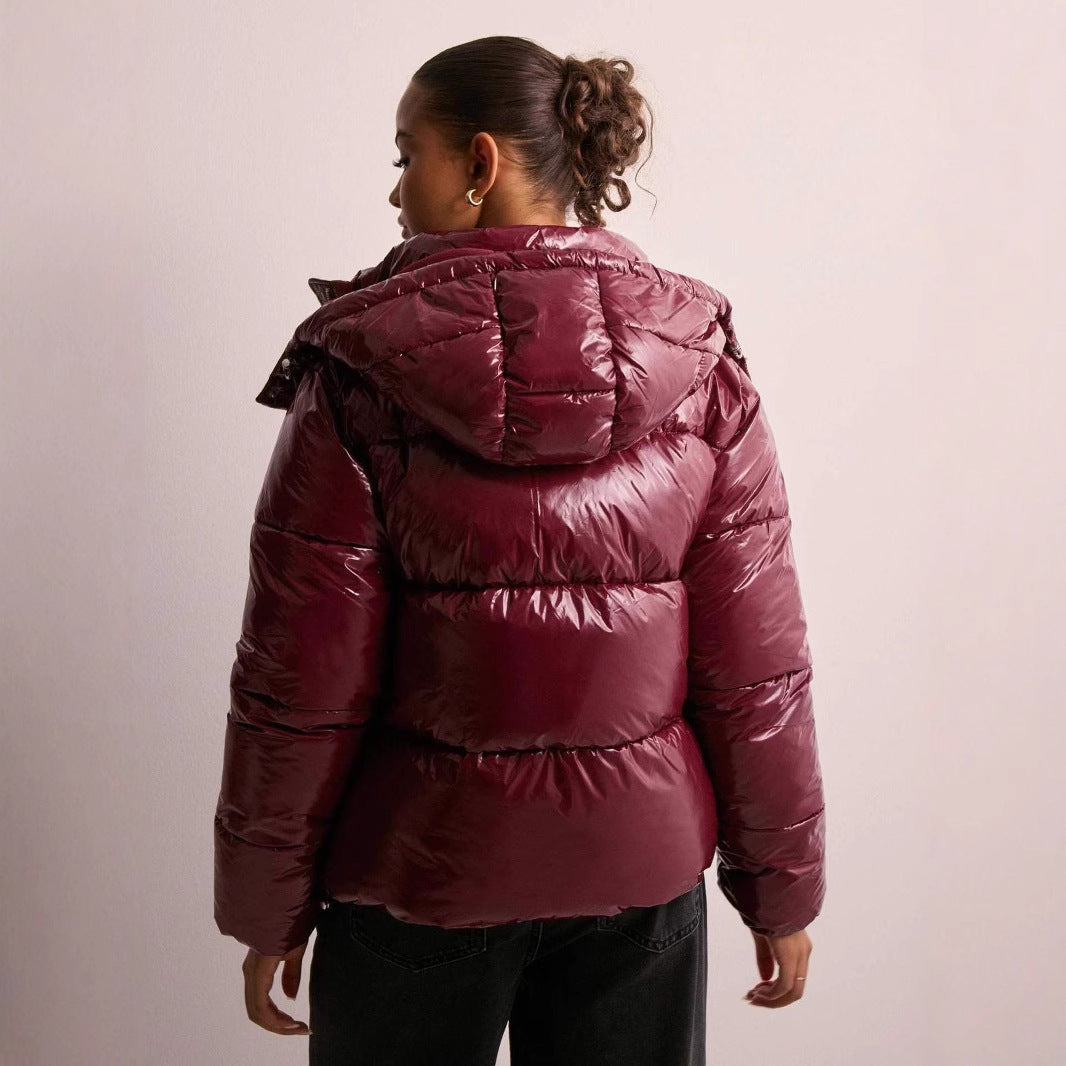 Back view of a women's casual wear quilted jacket, showcasing its shiny finish.