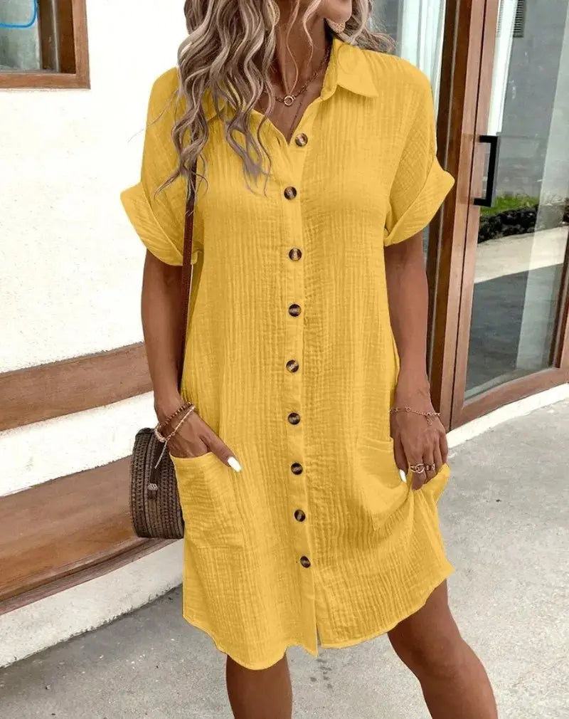 Women's collared short-sleeve midi shirt dress. Button-down front offers effortless, relaxed fit for summer.