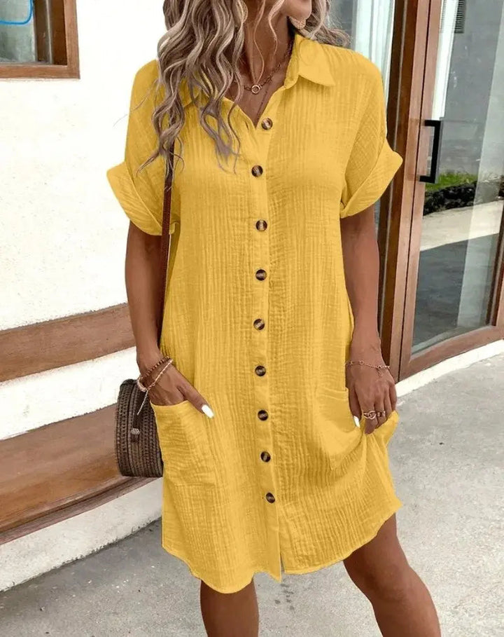 Women's collared short-sleeve midi shirt dress. Button-down front offers effortless, relaxed fit for summer.