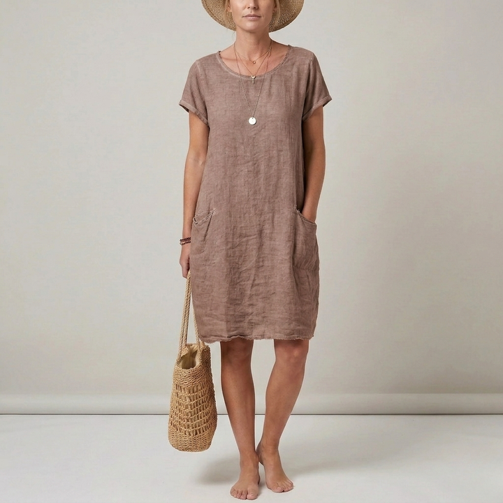 Comfortable women's short sleeve casual mini dress. Versatile shift style with pockets, ideal for warm weather.