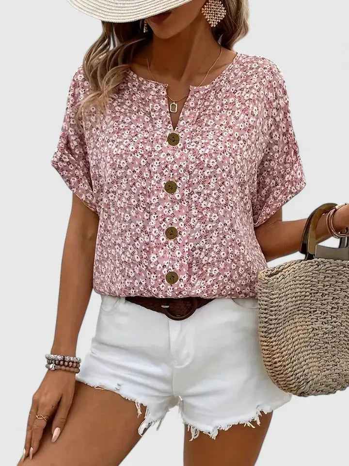 Women's short sleeve floral print summer blouse. Features button front, vintage style, and a cute, feminine look.