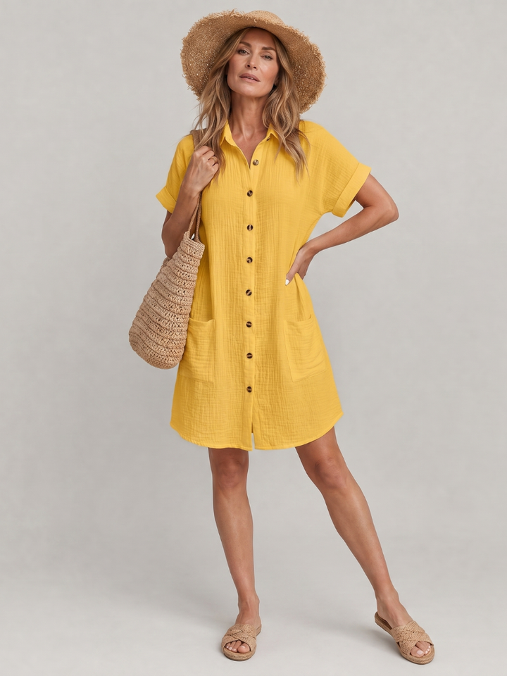 Women's short sleeve knee length dress with practical pockets for casual summer wear.