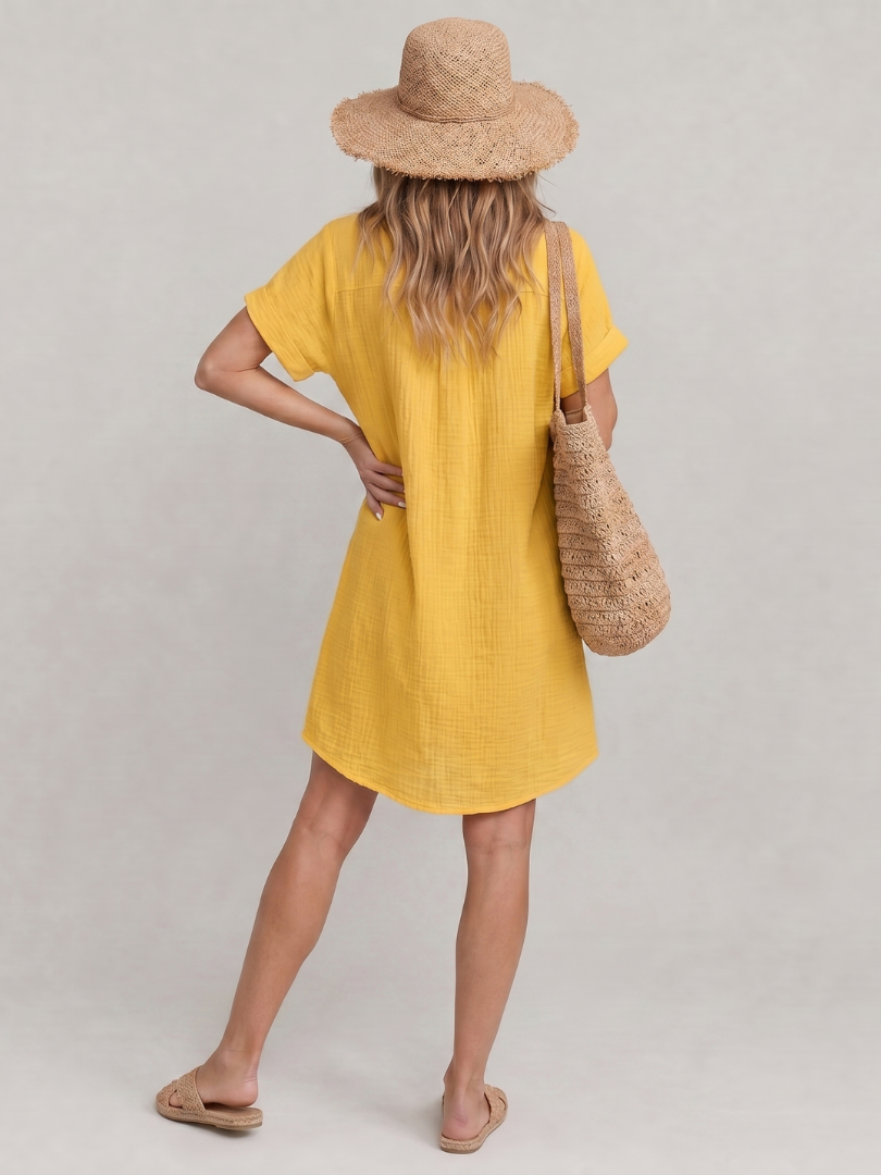 Collared women's short sleeve knee length dress with button front and convenient side pockets.