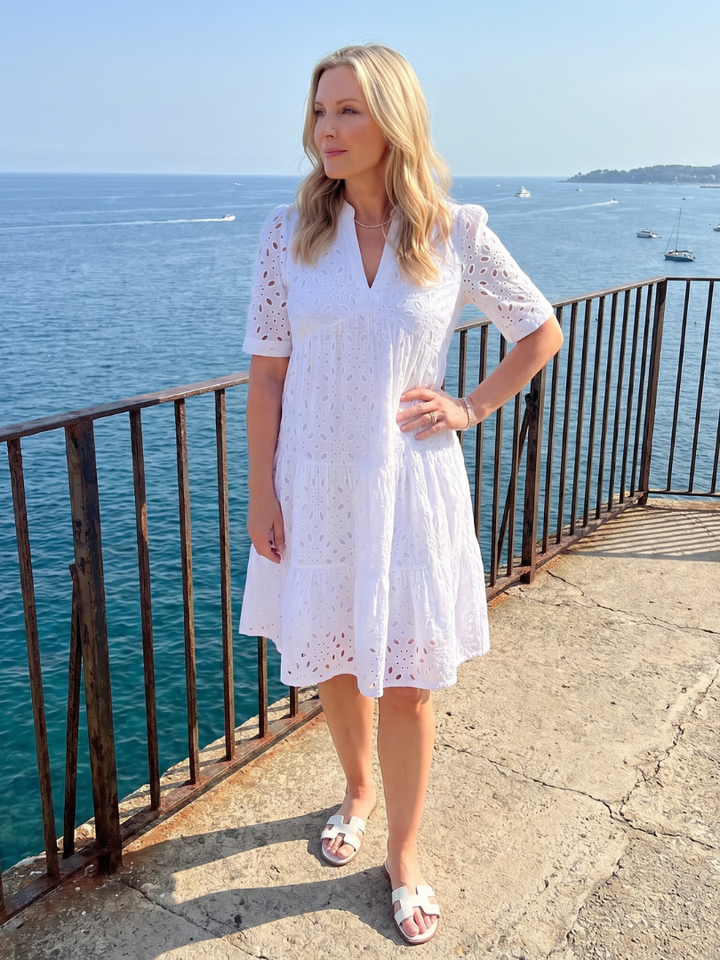 Comfortable women's eyelet dress, short sleeve, knee-length. Relaxed fit V-neck, ideal for summer daywear style.
