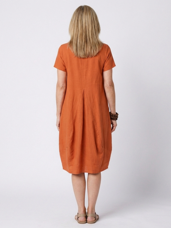 Relaxed fit women's summer dress with short sleeves and pleats, perfect for spring style.