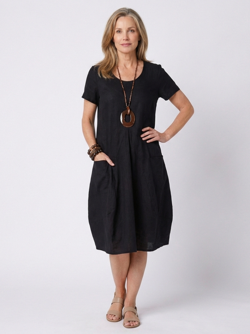 Stylish women's knee-length pleated dress, short sleeve design for relaxed summer comfort.