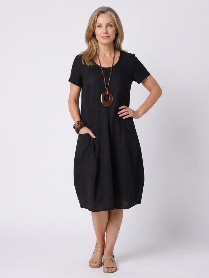 Stylish women's knee-length pleated dress, short sleeve design for relaxed summer comfort.