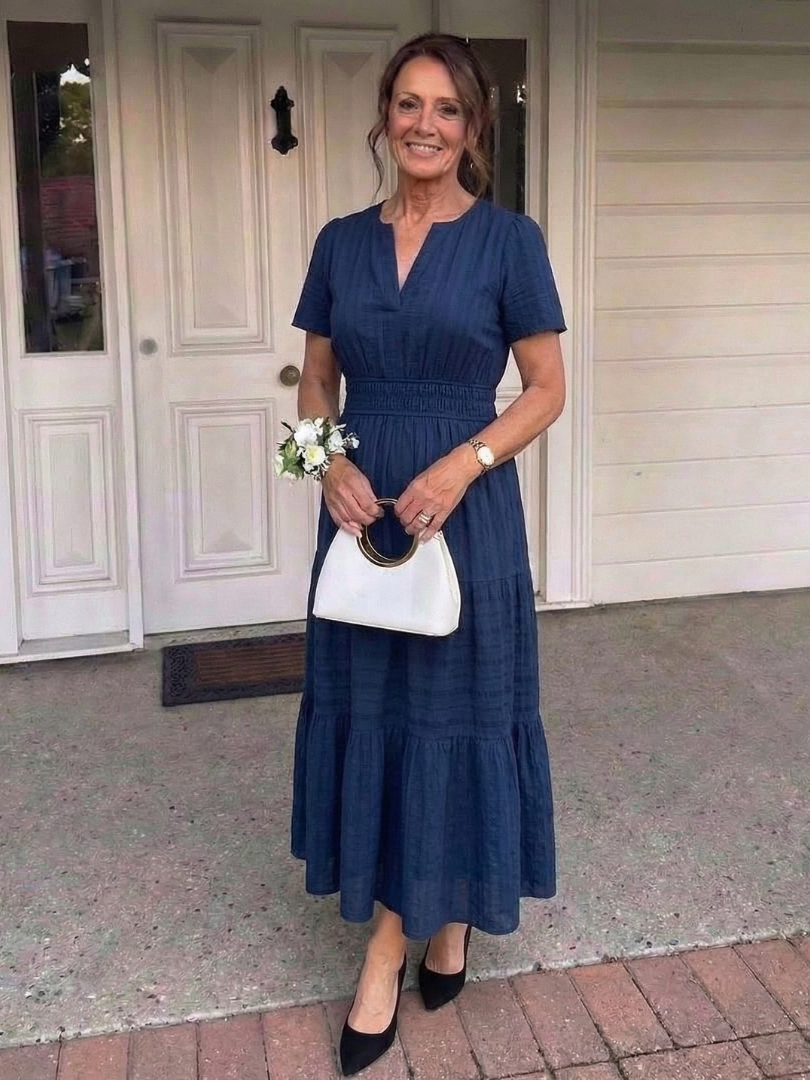 Navy women's short sleeve tiered maxi dress, featuring a smocked waist for casual summer and everyday wear.