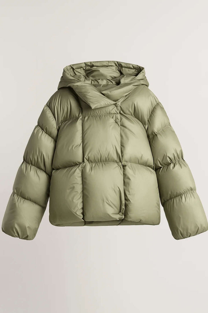 Voluminous women's fashion puffer jacket in silver grey. Warm, modern layering piece with oversized collar for winter.