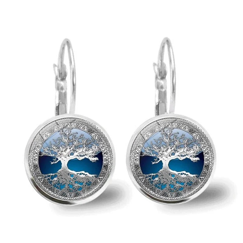 Close-up of blue & silver Tree of Life hoop earrings. Women's spiritual jewelry with lever back, elegant gift.