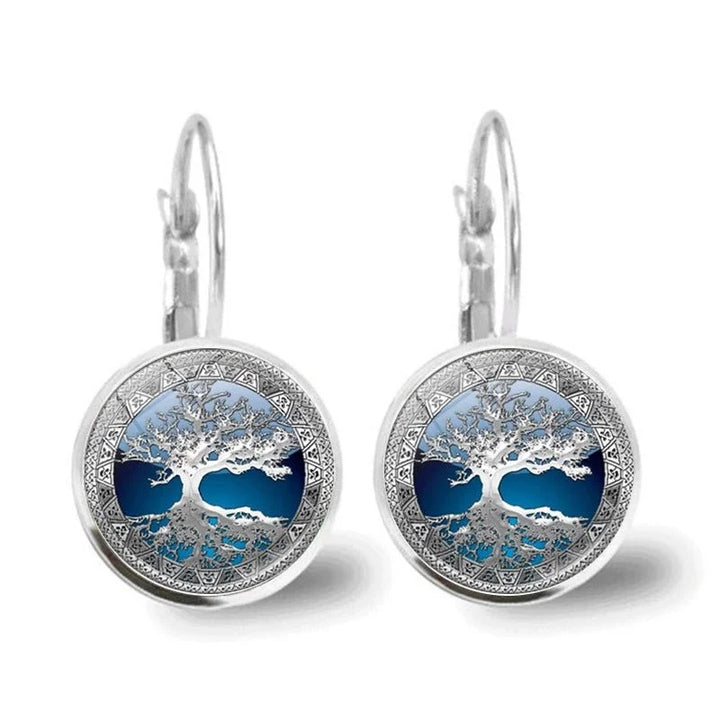 Close-up of blue & silver Tree of Life hoop earrings. Women's spiritual jewelry with lever back, elegant gift.