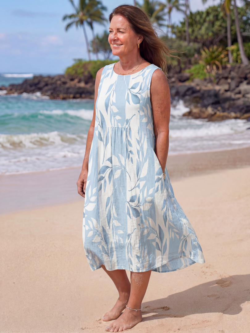 Close-up of women's relaxed fit midi dress, featuring a delicate sky blue botanical print, perfect for summer.