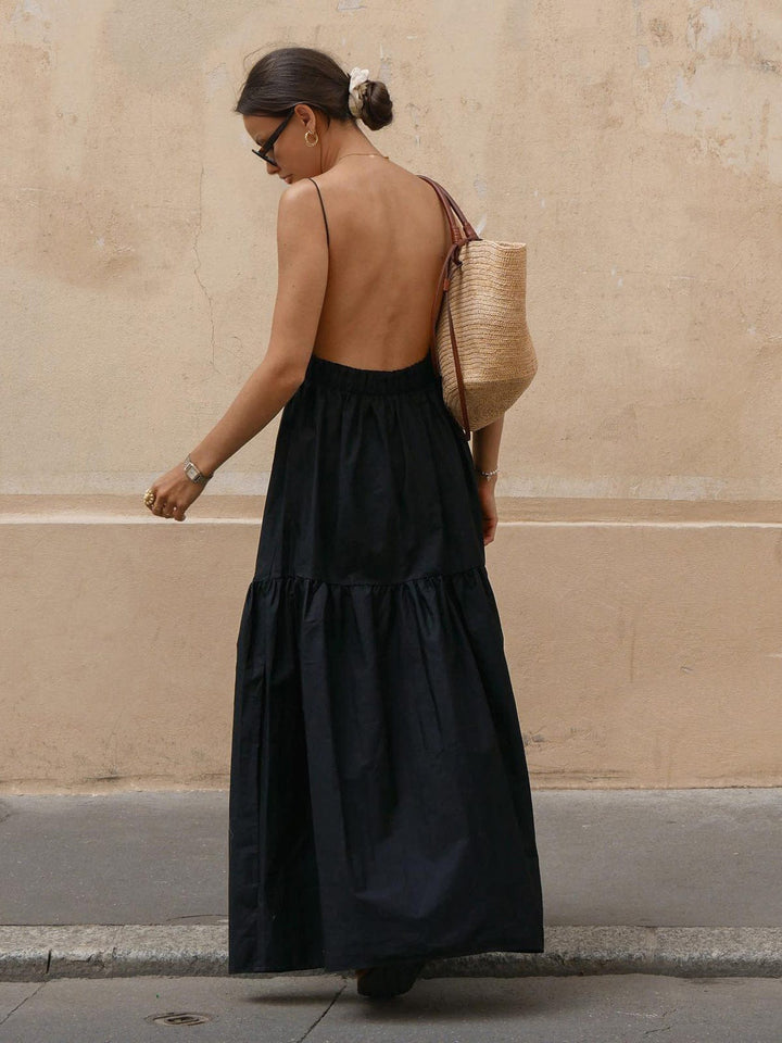 Stylish women's sleeveless backless midi dress for summer. Ideal for holiday, vacation, or elegant spring fashion.