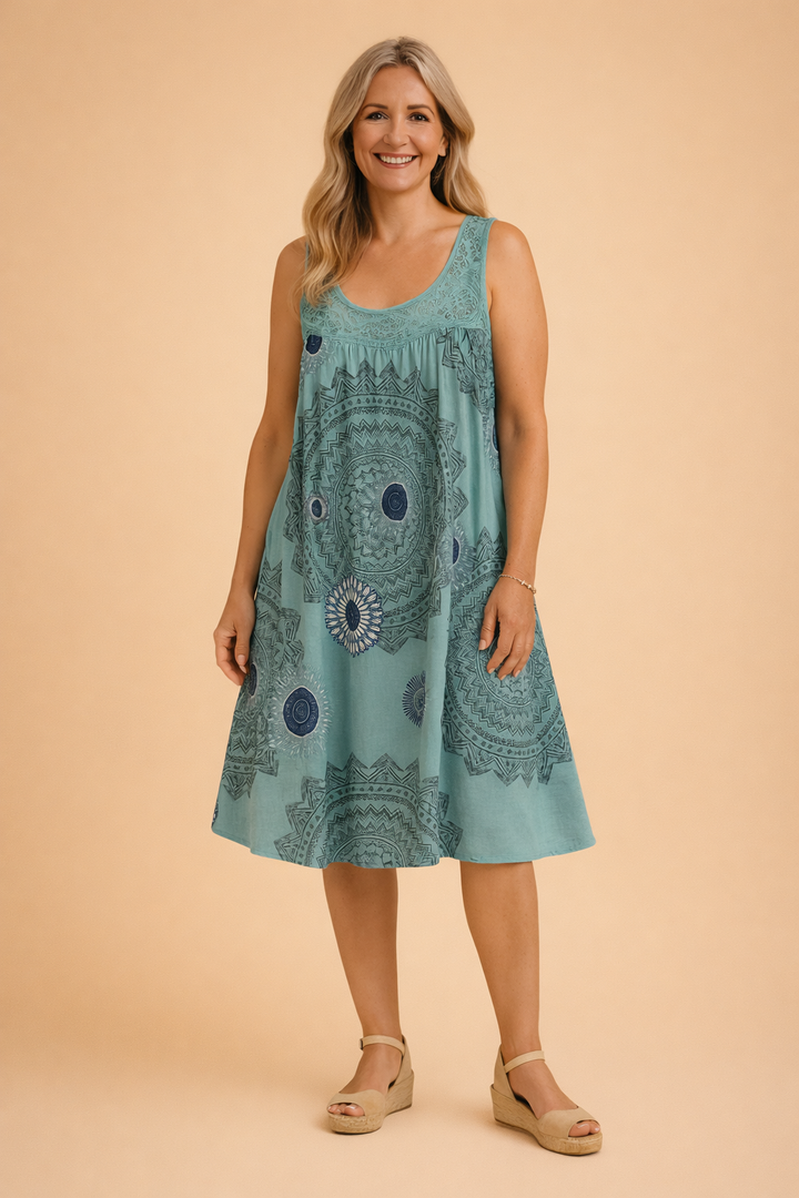 Vibrant mandala print on a sleeveless, flowy women's midi dress, designed for comfortable summer wear.