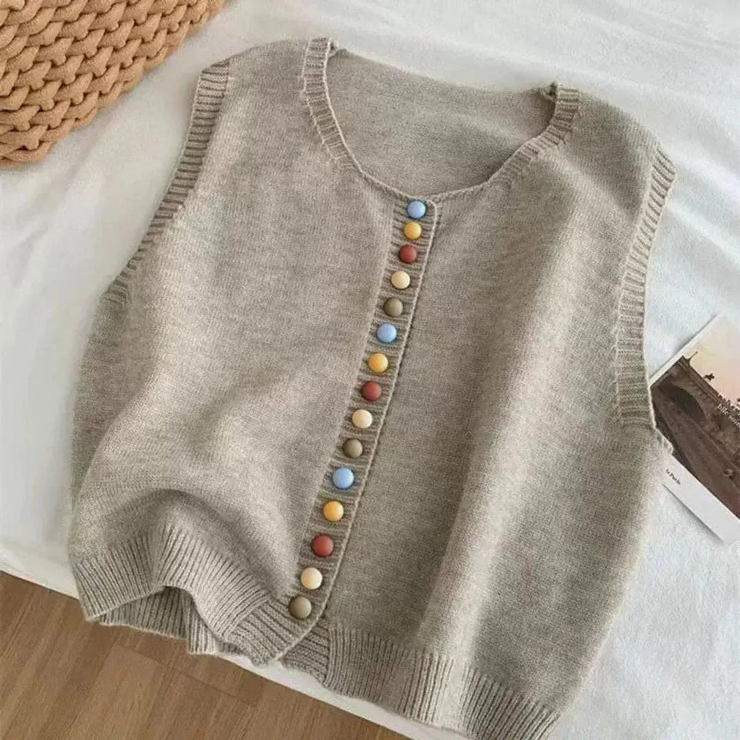 Waist-length women's sleeveless vest. Button-front cardigan with eye-catching multi-color buttons for casual wear.