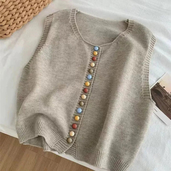 Waist-length women's sleeveless vest. Button-front cardigan with eye-catching multi-color buttons for casual wear.