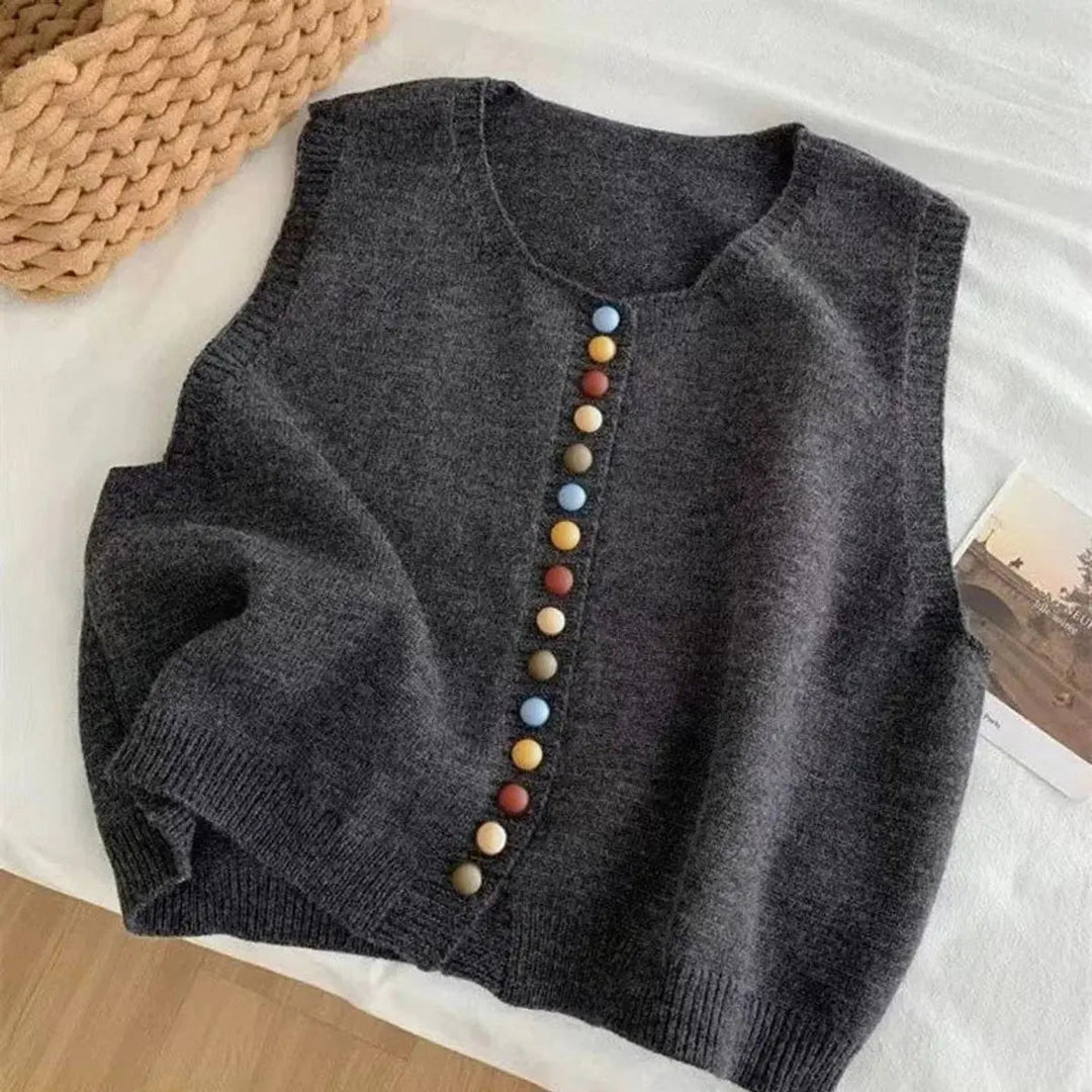 Elegant women's sleeveless button-front cardigan vest. Features unique colorful buttons & a comfortable round neck.
