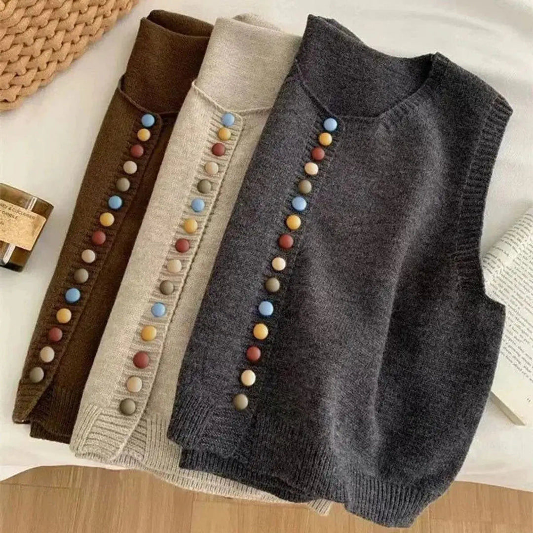 Stylish women's sleeveless button-front vest, perfect for layering. Features a round neck & colorful button details.