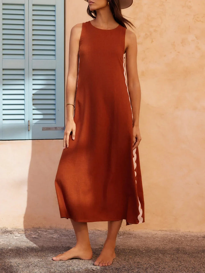 Black sleeveless midi dress with wavy contrast trim, elegant round neck design. Perfect for summer fashion.