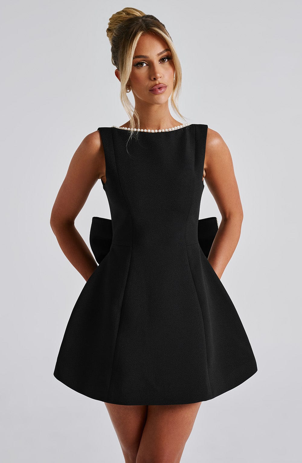 Formal sleeveless mini dress for women, sophisticated pearl neckline.