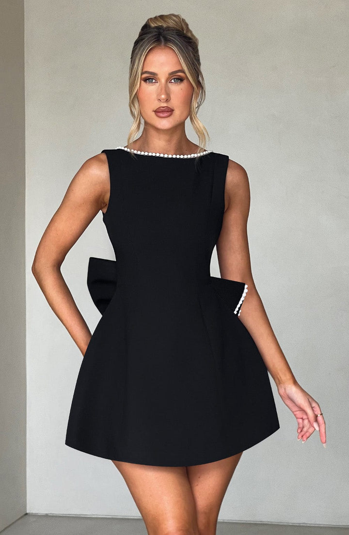 Chic occasion mini dress, sleeveless, pearl neckline for an elegant look.