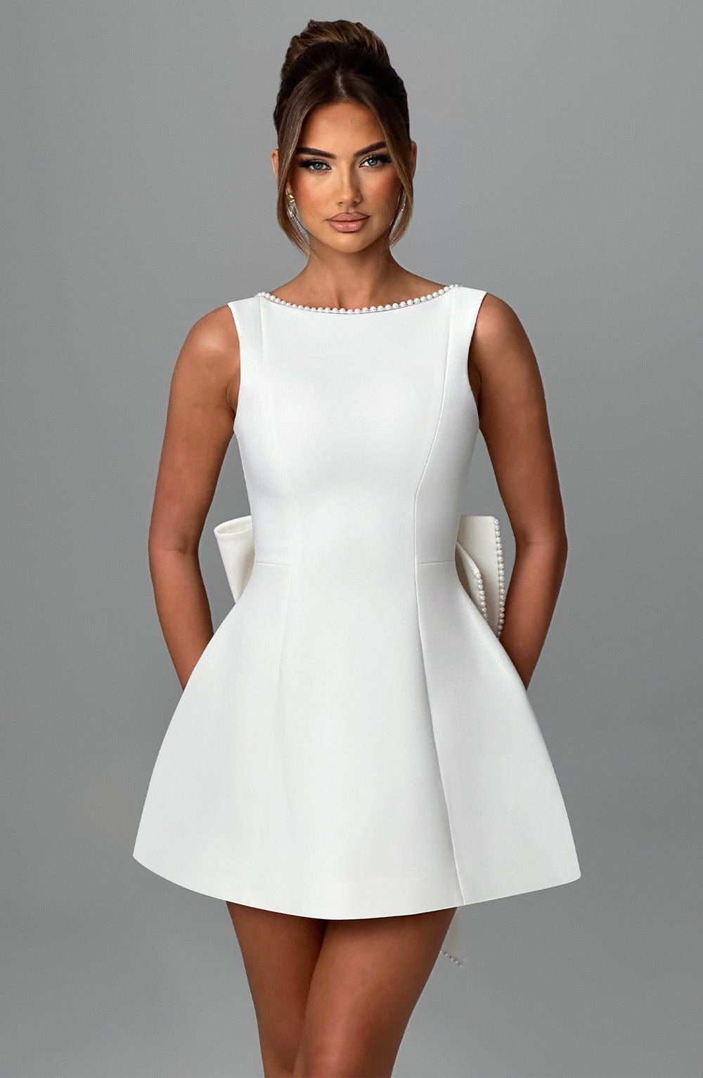 Party ready sleeveless mini dress for women, chic pearl neckline design.