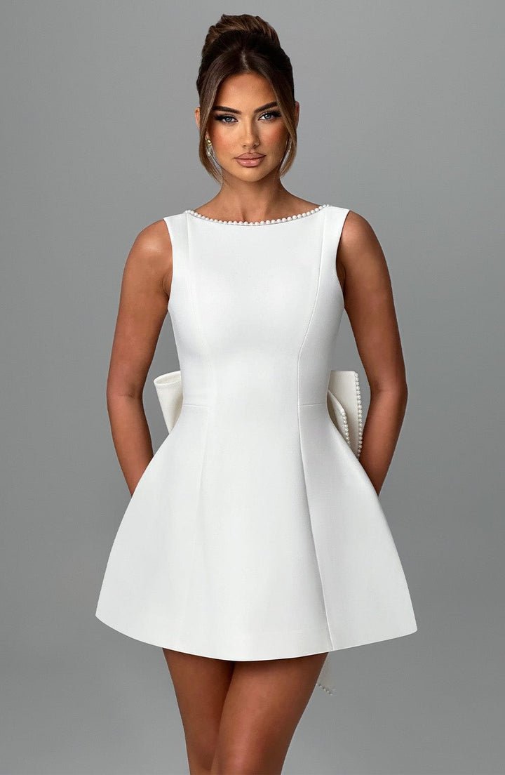 Party ready sleeveless mini dress for women, chic pearl neckline design.