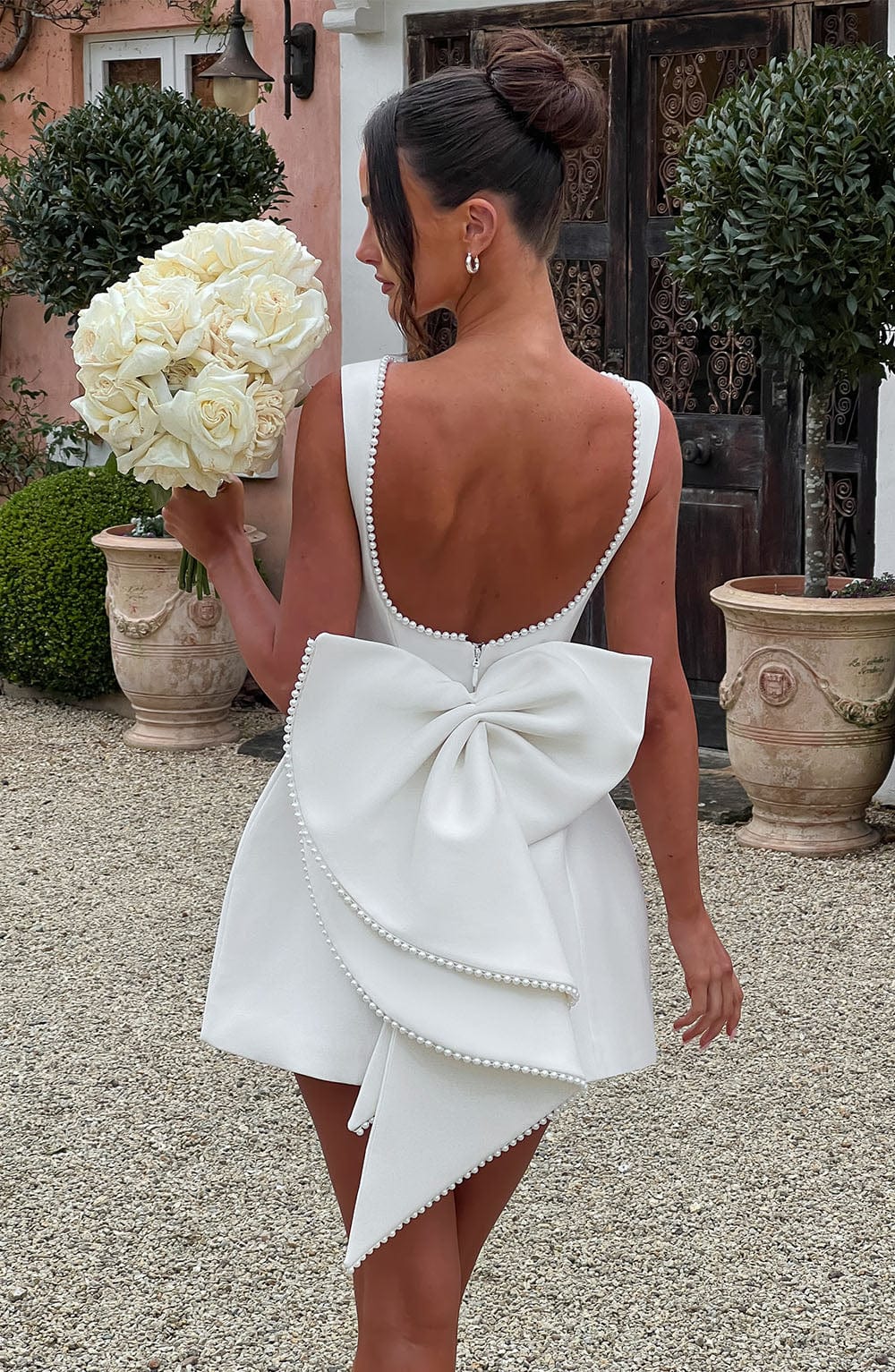 Classic women's sleeveless mini dress, elegant pearl neckline for timeless style.