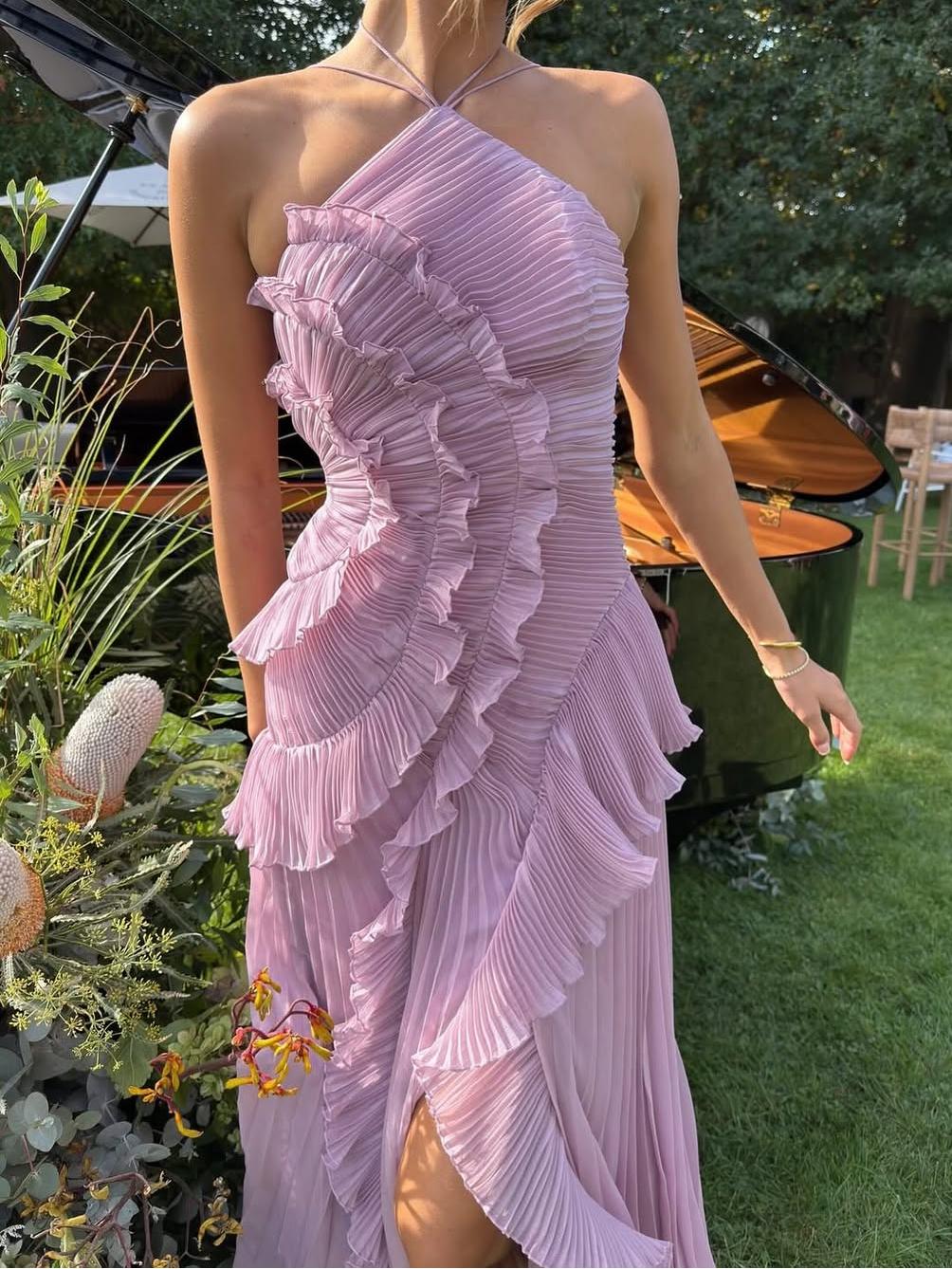 Formal women's sleeveless maxi dress, featuring elegant pleats & an asymmetric hemline.
