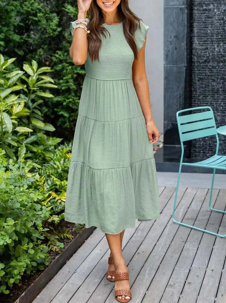 Women's sleeveless smocked midi dress, perfect for summer casual wear or vacation.