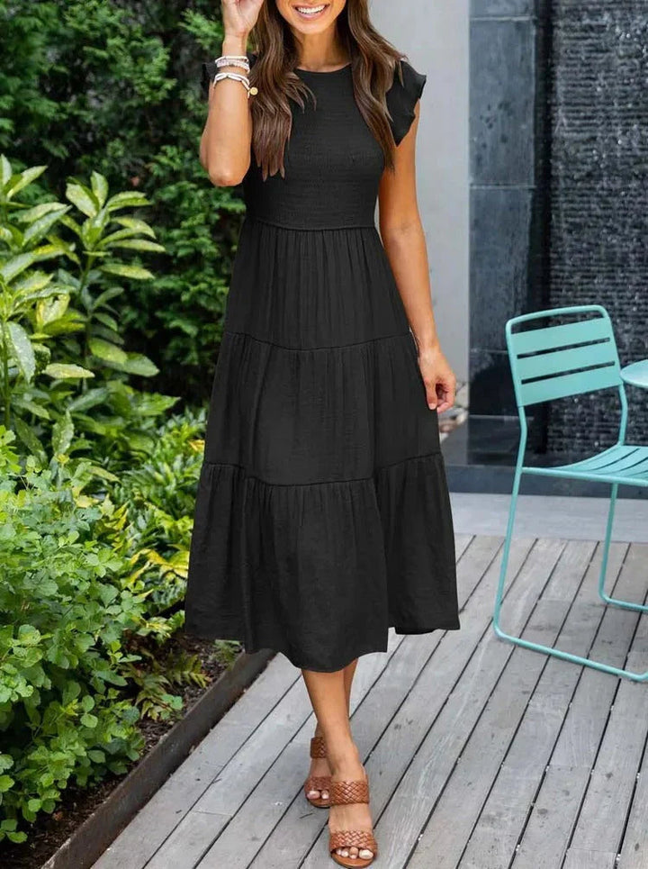 Close-up of smocked bodice on a women's sleeveless A-line midi dress, perfect for summer comfort.