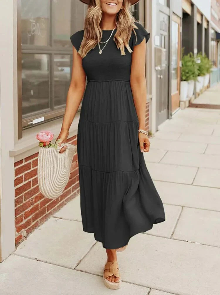 Back view of women's elegant sleeveless smocked midi dress, flowy and comfortable for summer wear.