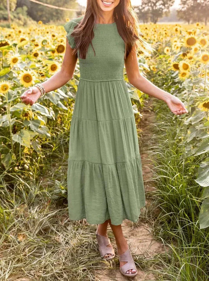 Elegant smocked bodice sleeveless midi dress in a flowy A-line style for women.