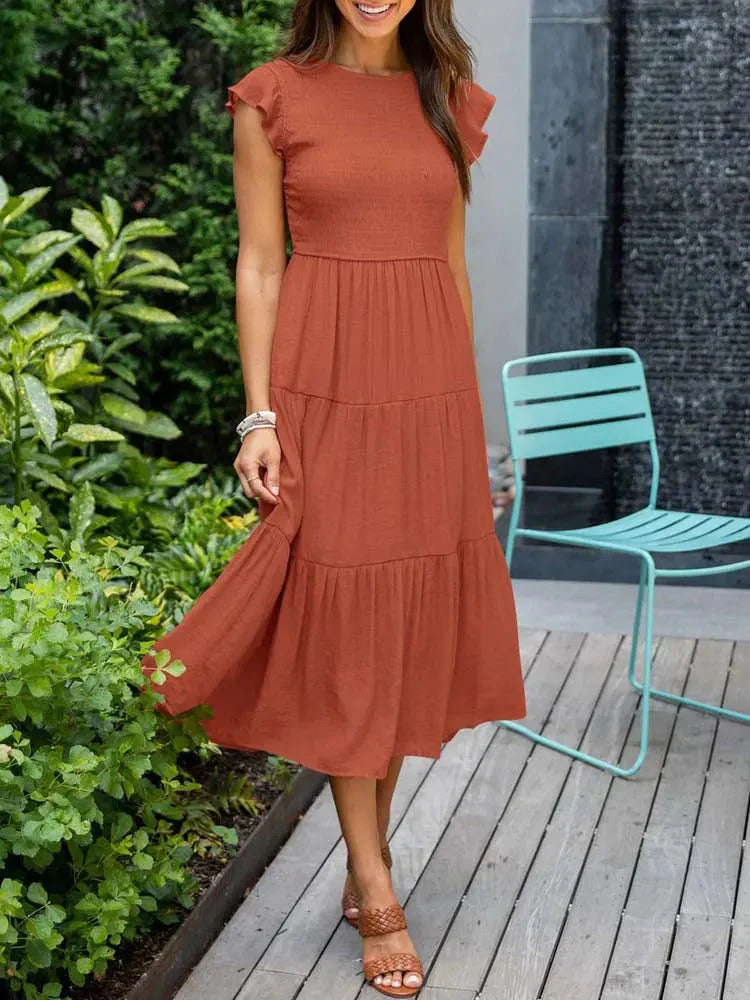 Fashionable A-line sleeveless midi dress with smocked detailing, ideal for women's summer elegance.