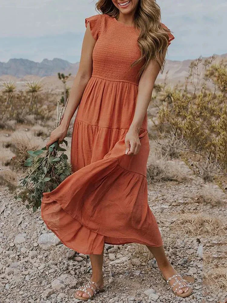 Chic blue sleeveless smocked midi dress, a comfortable women's summer vacation outfit.