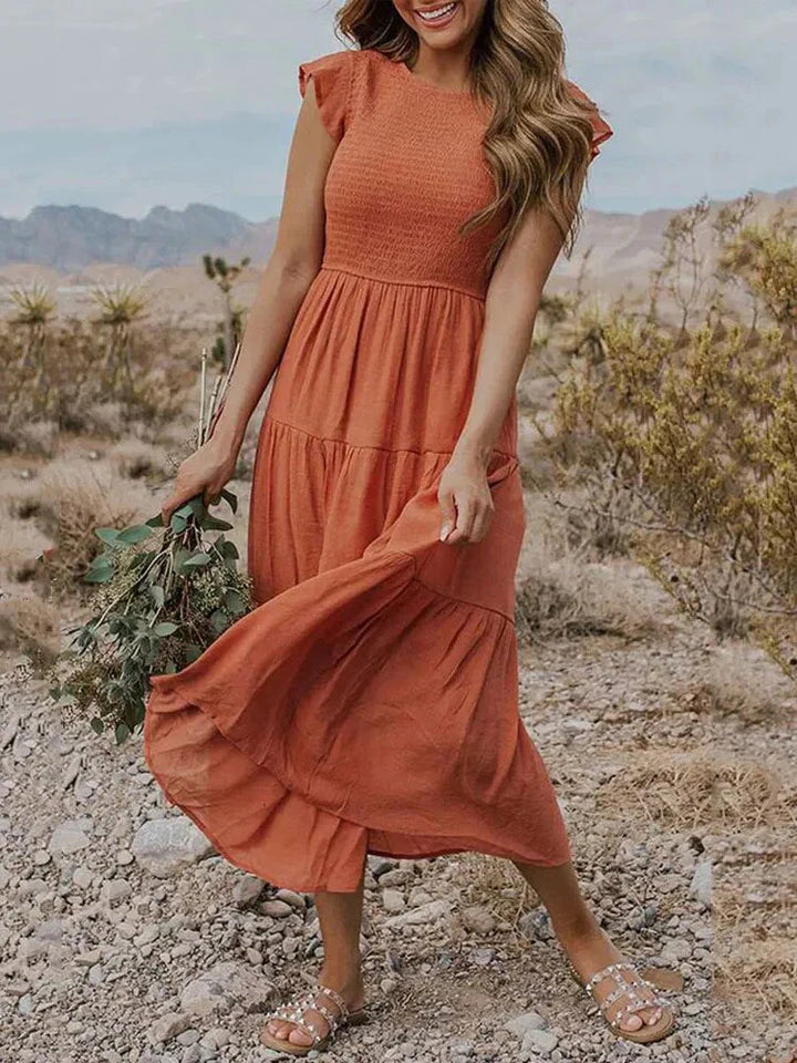 Chic blue sleeveless smocked midi dress, a comfortable women's summer vacation outfit.