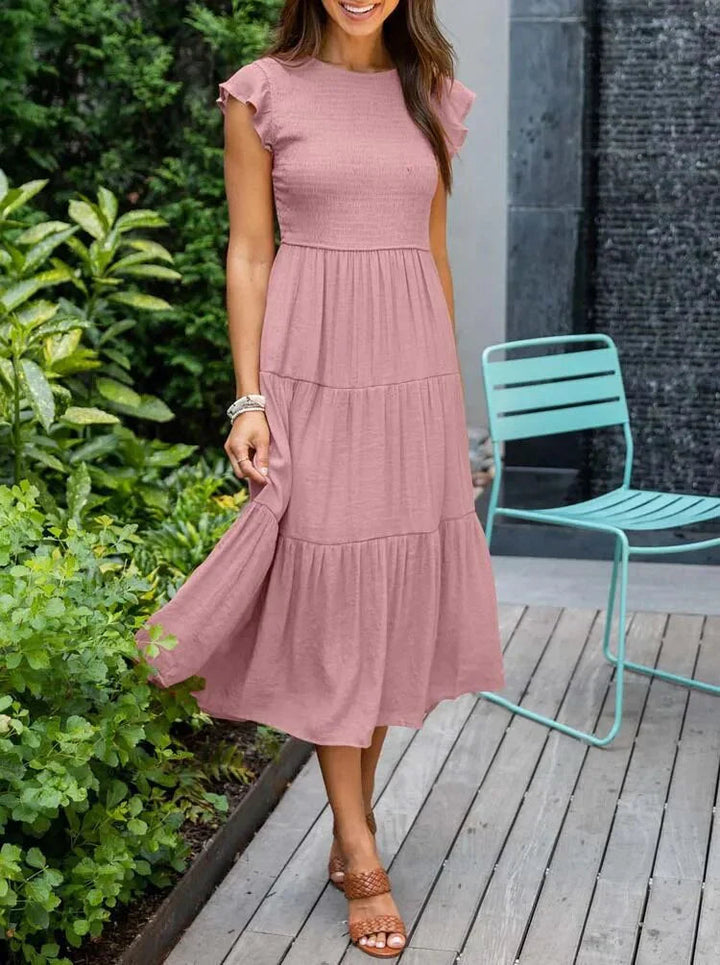 Flowy sleeveless smocked midi dress for women, offering comfortable and elegant summer style.
