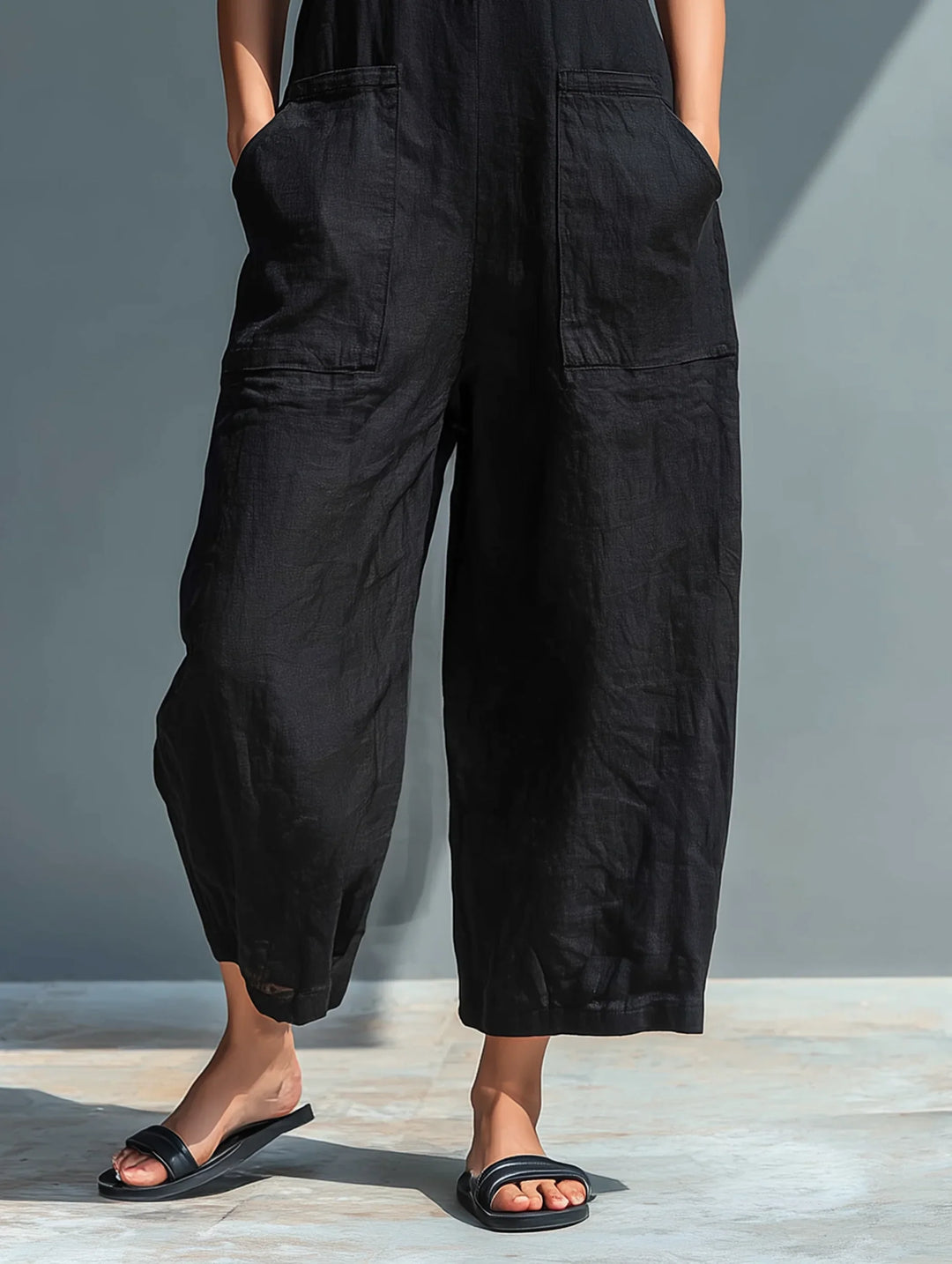 Summer-ready women's sleeveless wide-leg jumpsuit. Mandarin collar & button front make it a casual or elegant outfit.