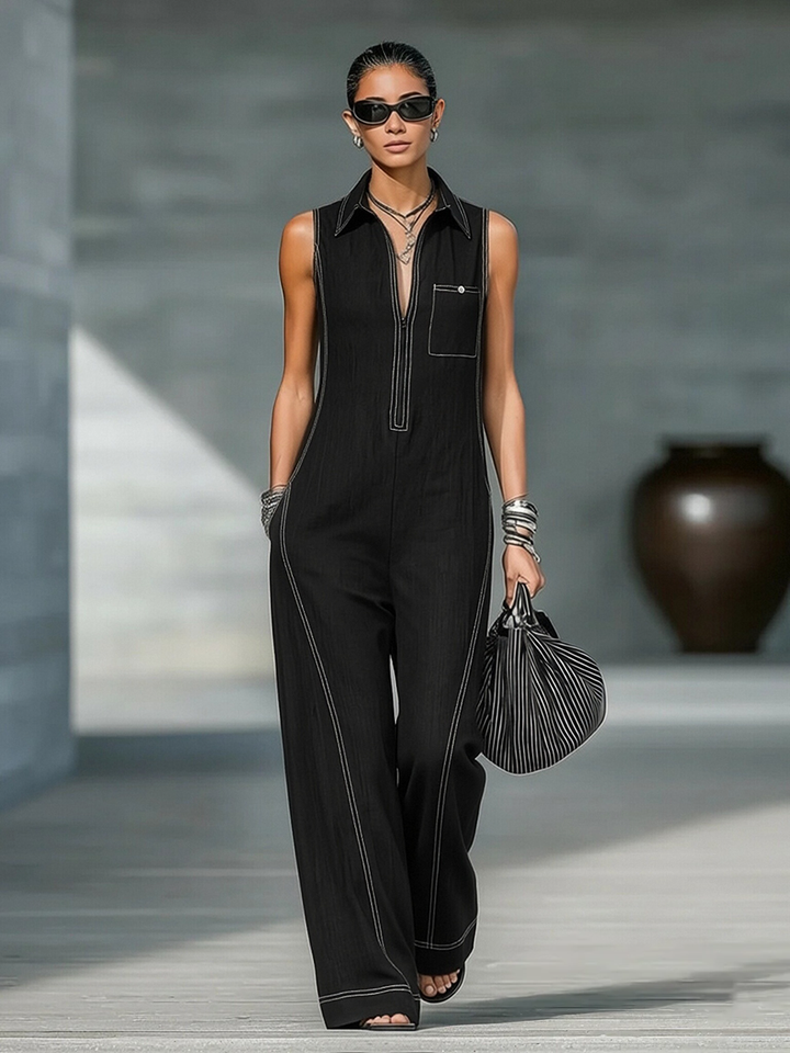 Model wearing a stylish women's sleeveless wide leg jumpsuit with prominent contrast stitching. Chic and comfortable.