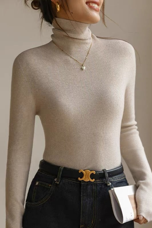 Elegant women's slim-fit turtleneck, seamless and warm for effortless layering. A modern fall/winter staple.
