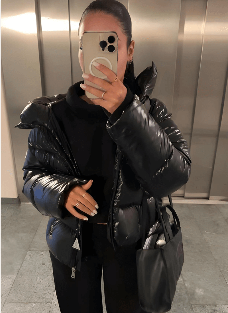 Glossy women's puffer jacket with a slim-fit design, offering stylish winter warmth. Trendy ladies' fashion.