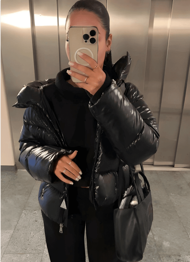 Glossy women's puffer jacket with a slim-fit design, offering stylish winter warmth. Trendy ladies' fashion.