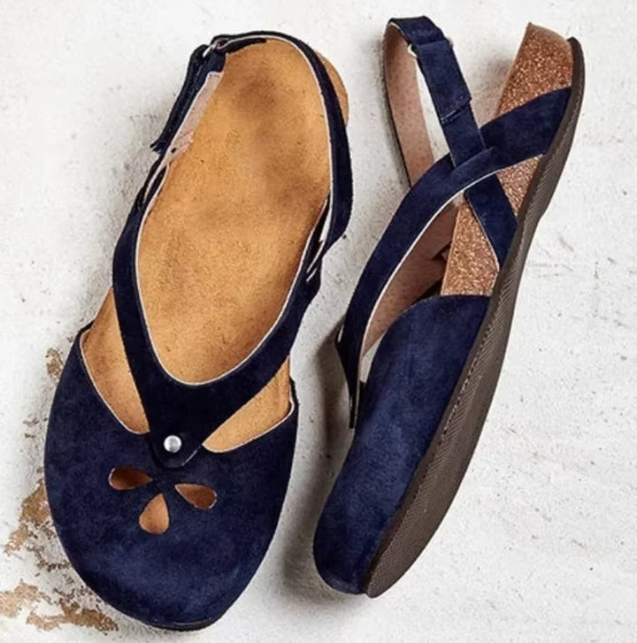 Comfortable women's slingback sandals, closed toe with intricate floral cut-outs, ideal for everyday summer wear.