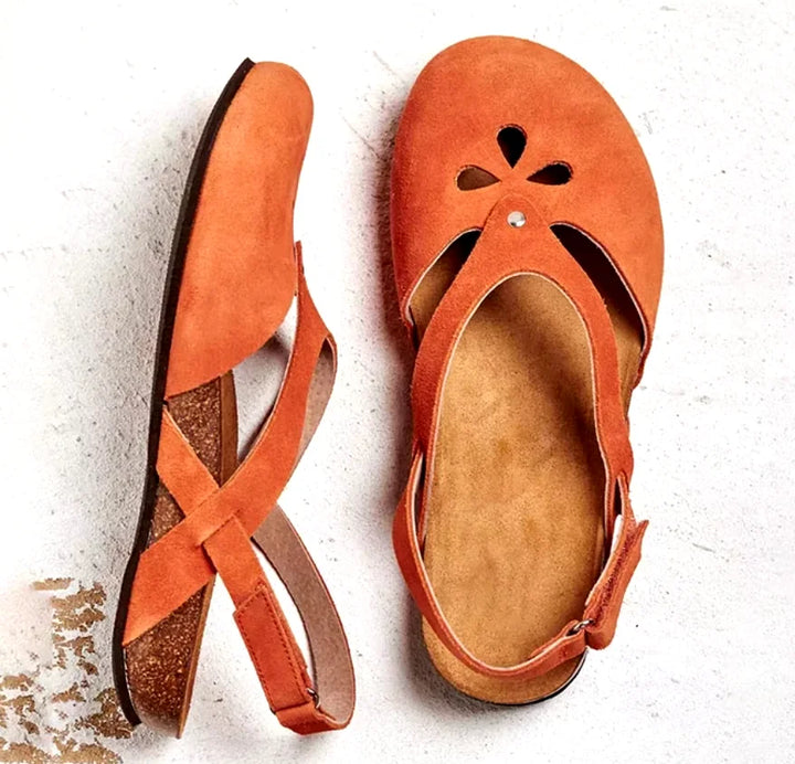 Lightweight women's slingback sandals featuring decorative floral cut-outs and a protective closed toe design.
