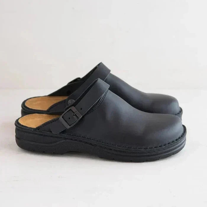 Ladies' comfortable flat slip-on sandals with stylish open-toe design and eye-catching contrast stitching.